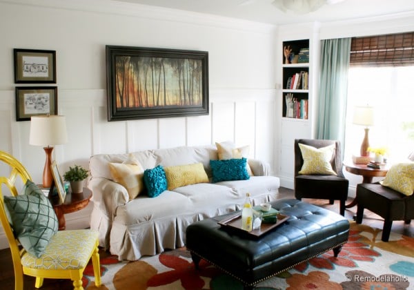Living Room Remodel With Board And Batten Yellow Accents Wood Floors And Built In Bookcases And Columns With Arches