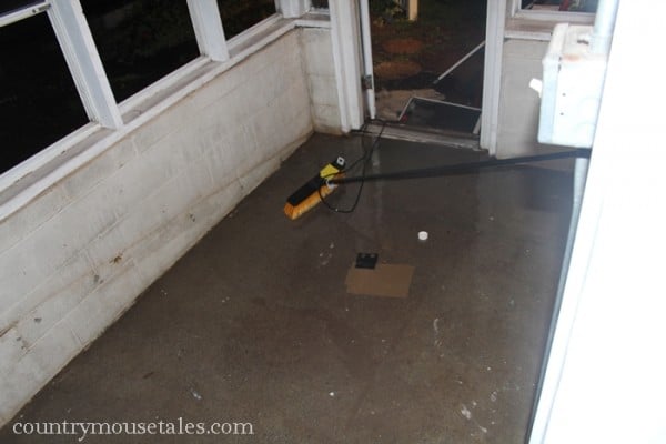 preparing a concrete floor for painting by scrubbing and etching