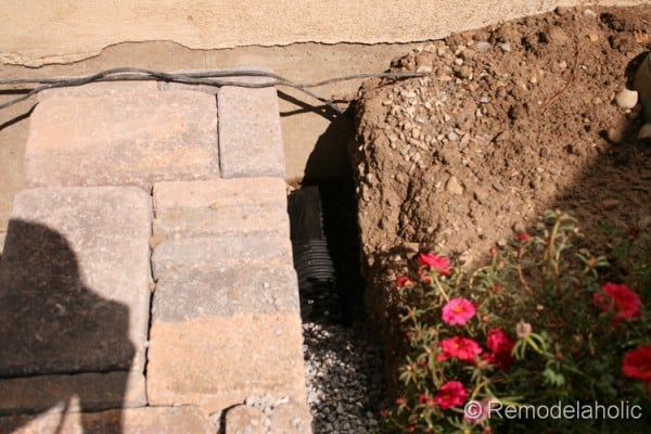 How to build a retaining wall with a drain pipe from Remodelaholic