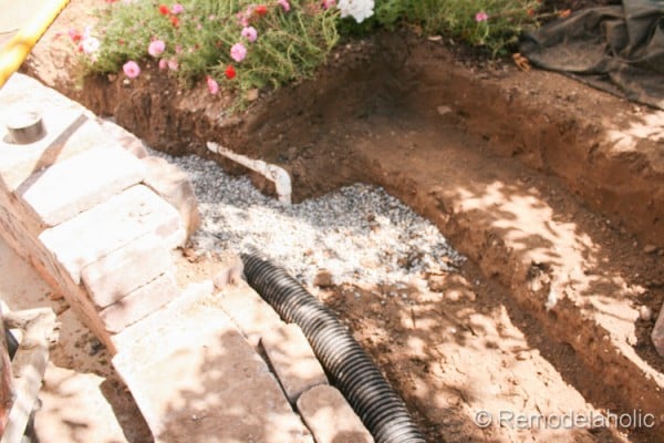 How to build a retaining wall with a drain pipe and steps from Remodelaholic