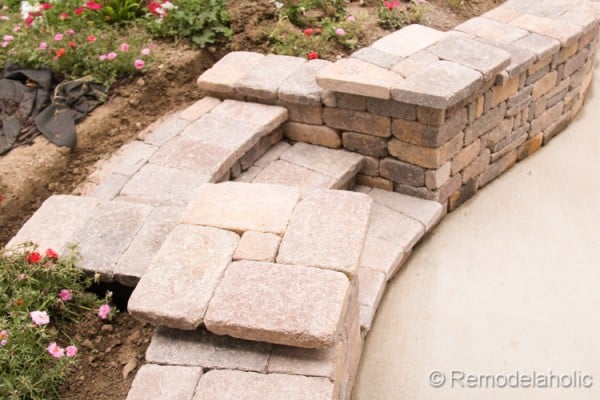 How to build a retaining wall with steps and platforms for flower pots, from Remodelaholic