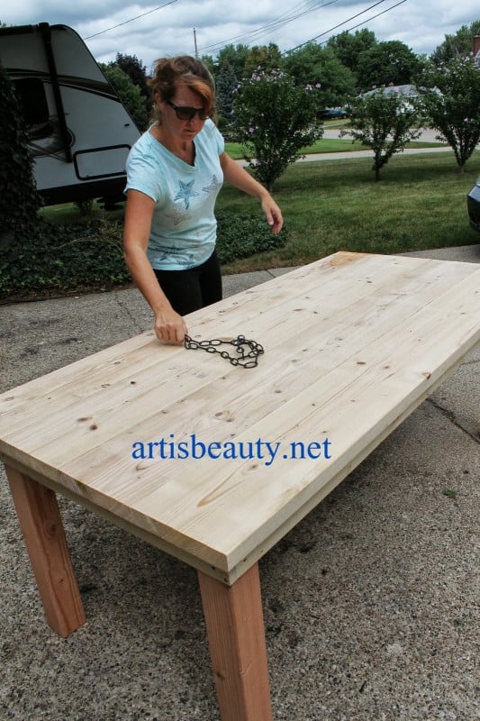 use a chain to give the farmhouse table character, featured on Remodelaholic.com