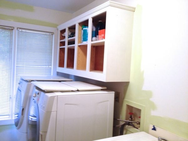 low cost laundry room makeover in soothing aloe green, featured on Remodelaholic
