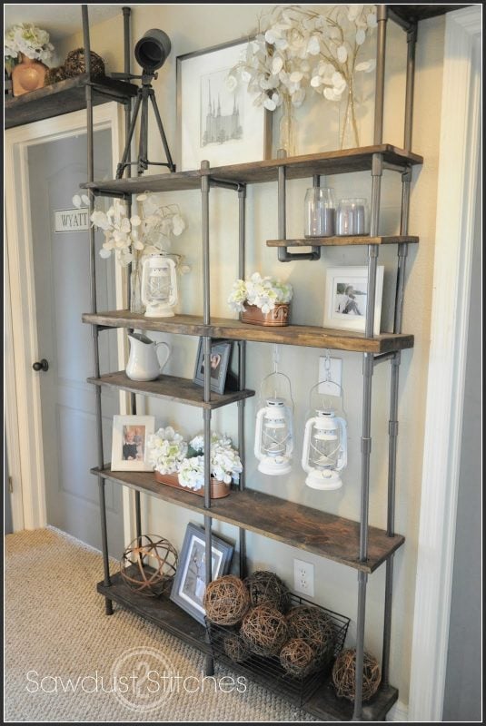 Build a CHEAP industrial-style shelf by using PVC instead of metal!  Get the tutorial from Sawdust2Stitches on Remodelaholic.com