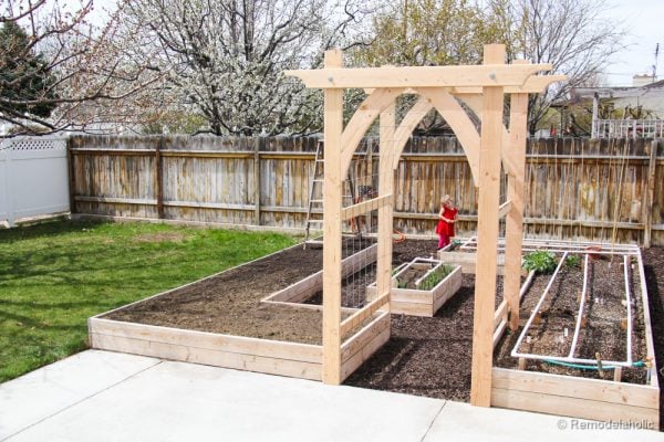 Add a raised garden bed with trellis and arbor that you can build yourself featured on Remodelaholic.com