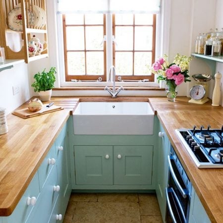 horseshoe small kitchen layout with aqua cabinets and wood countertops via House to Home
