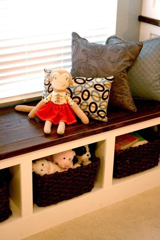great wall of built-ins with toy storage bench and cupboards, Remodelaholic